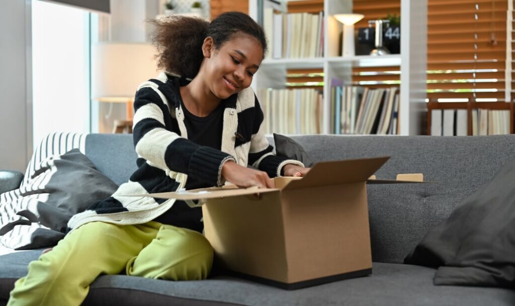 satisfied-young-african-american-woman-unpacking-d-2024-12-02-04-34-28-utc (2)